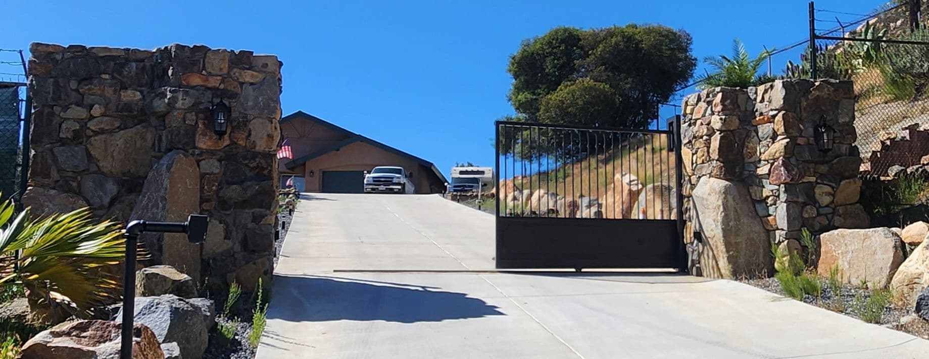 Custom Stone Pillars and Motorized Steel Gate in Harbison Canyon image